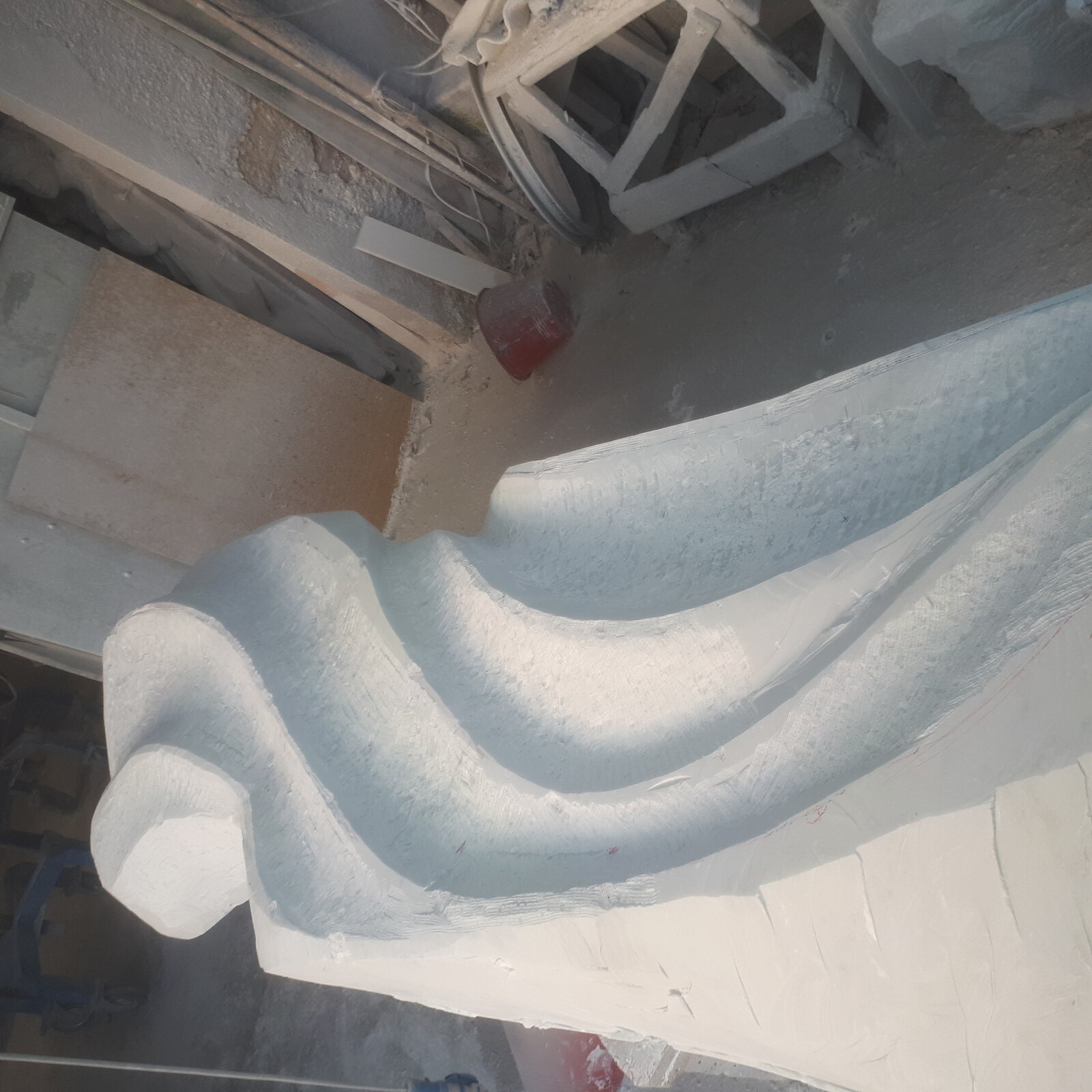 Forms emerging from a marble block midway through carving