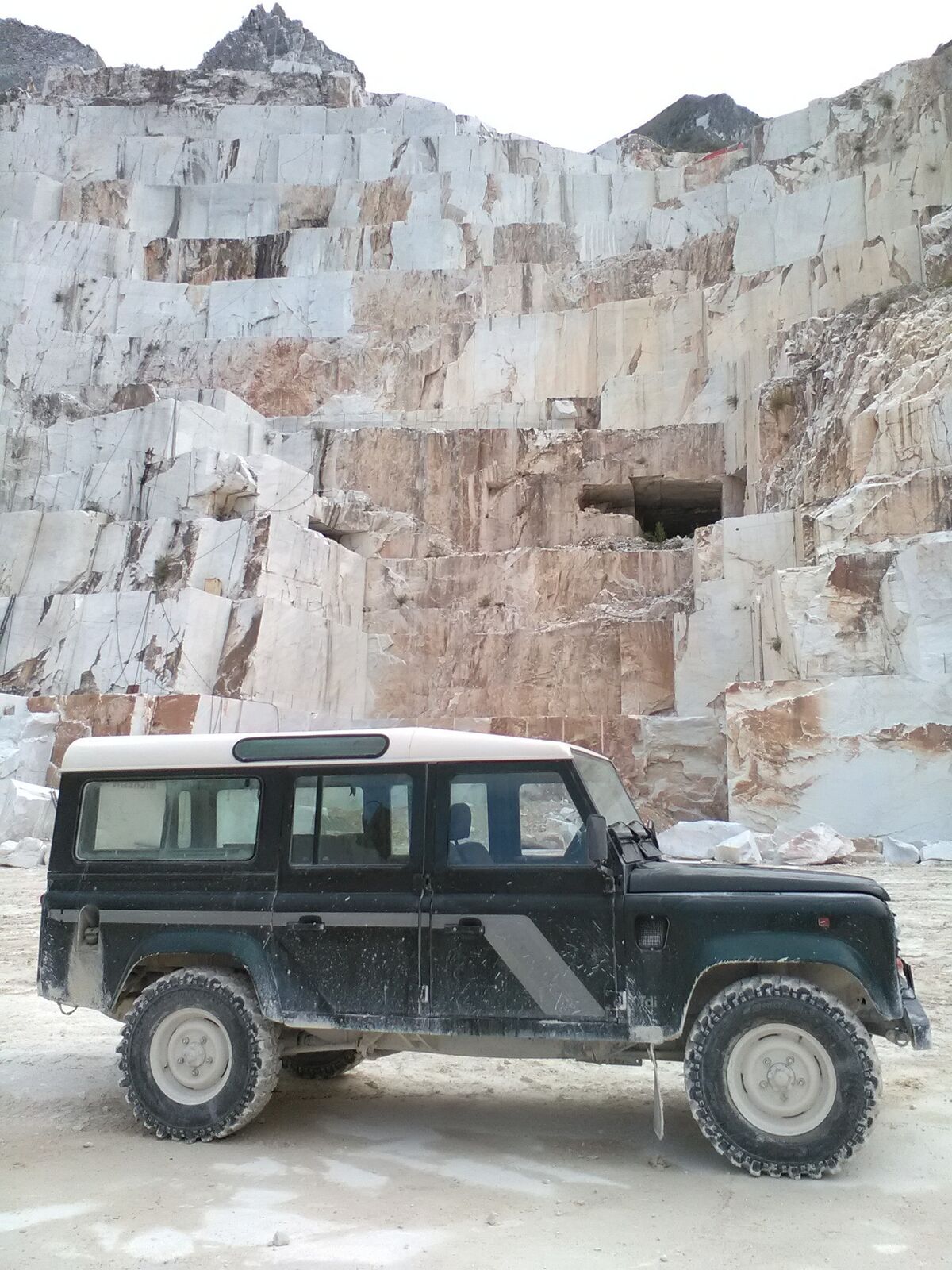 Arriving by Land Rover in the marble quarry landscape above Carrara, Tuscany