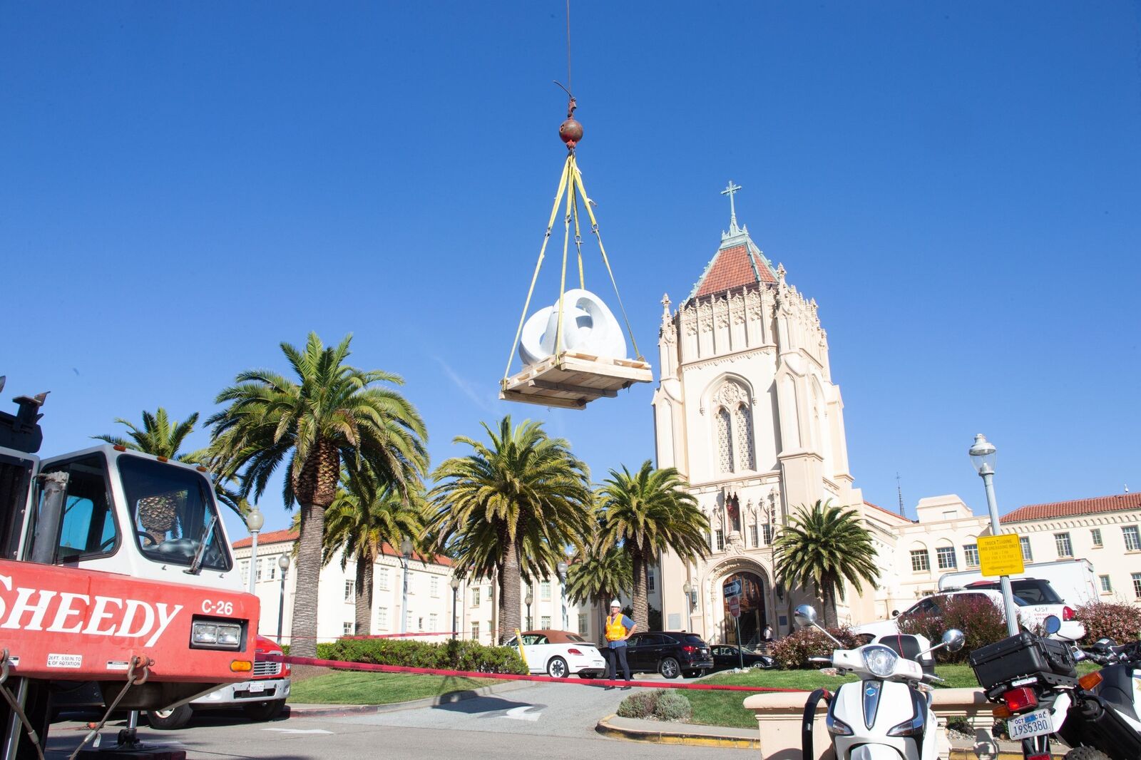 Crane installation of the marble sculpture Tides at the University of San Francisco