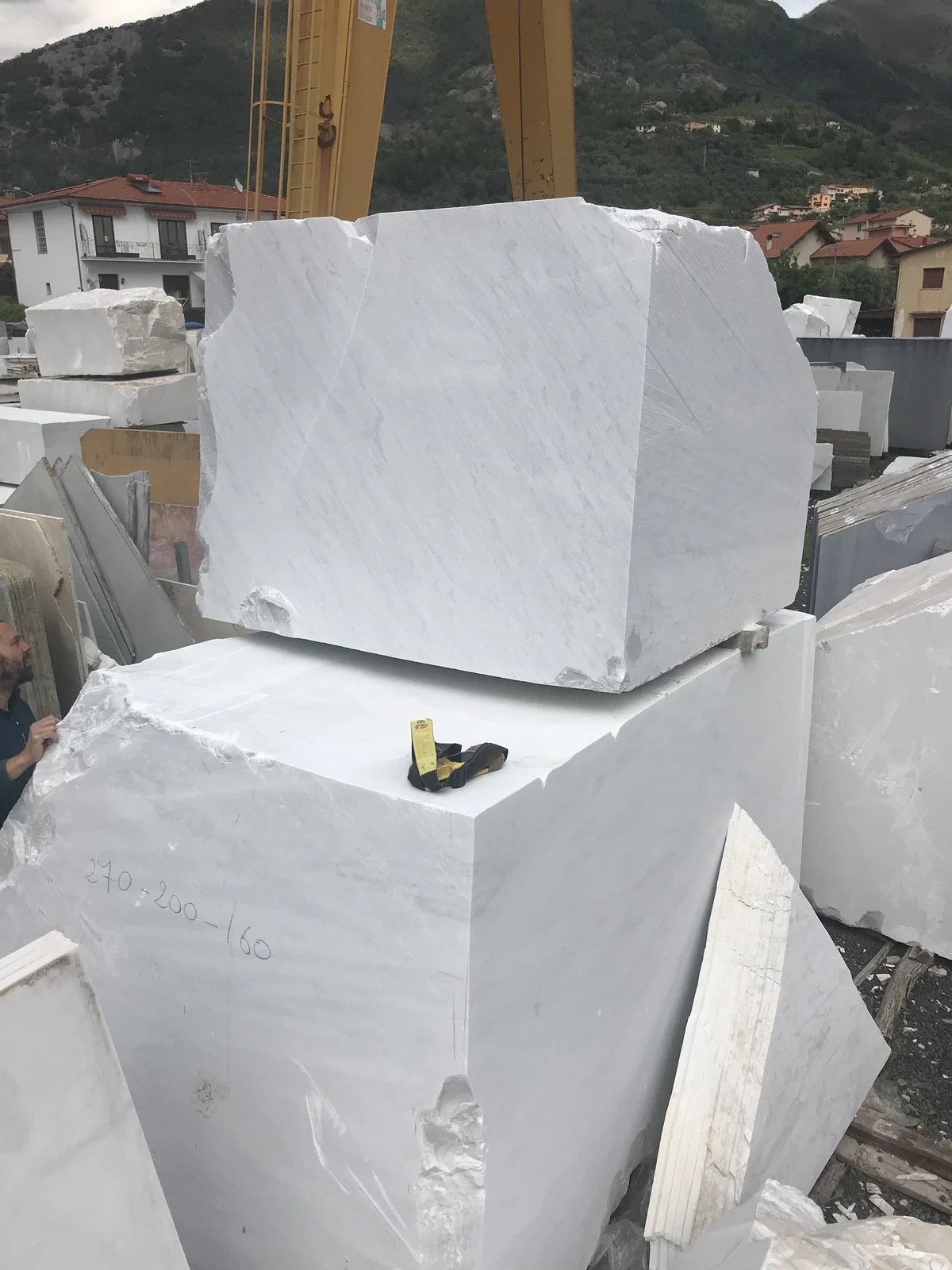 Large white marble blocks in a stone yard near Carrara