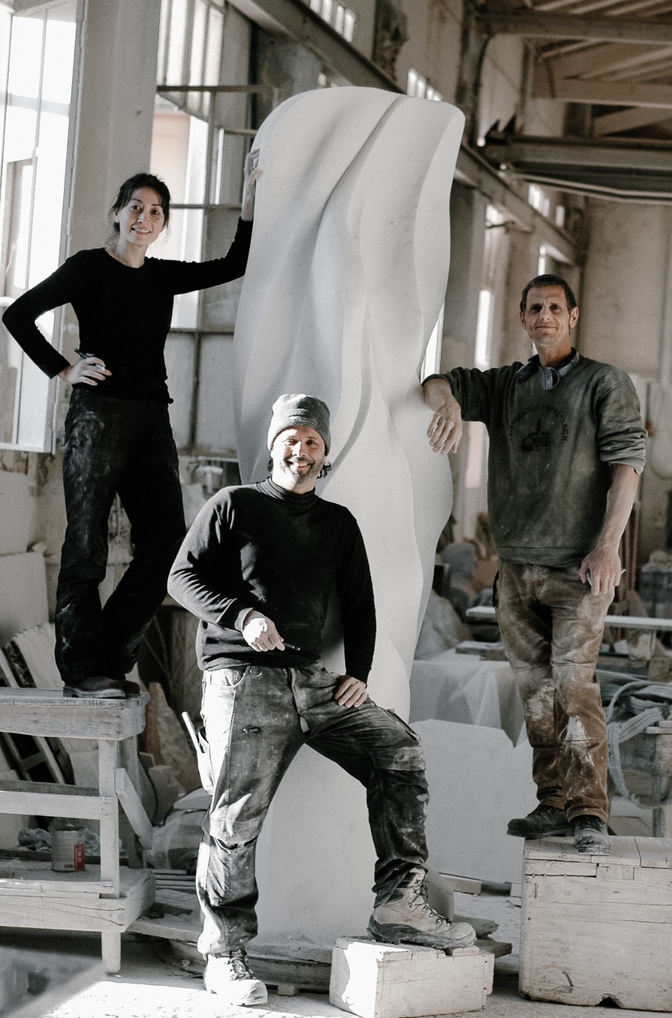 Artisans working alongside Yoko Kubrick in a Pietrasanta atelier