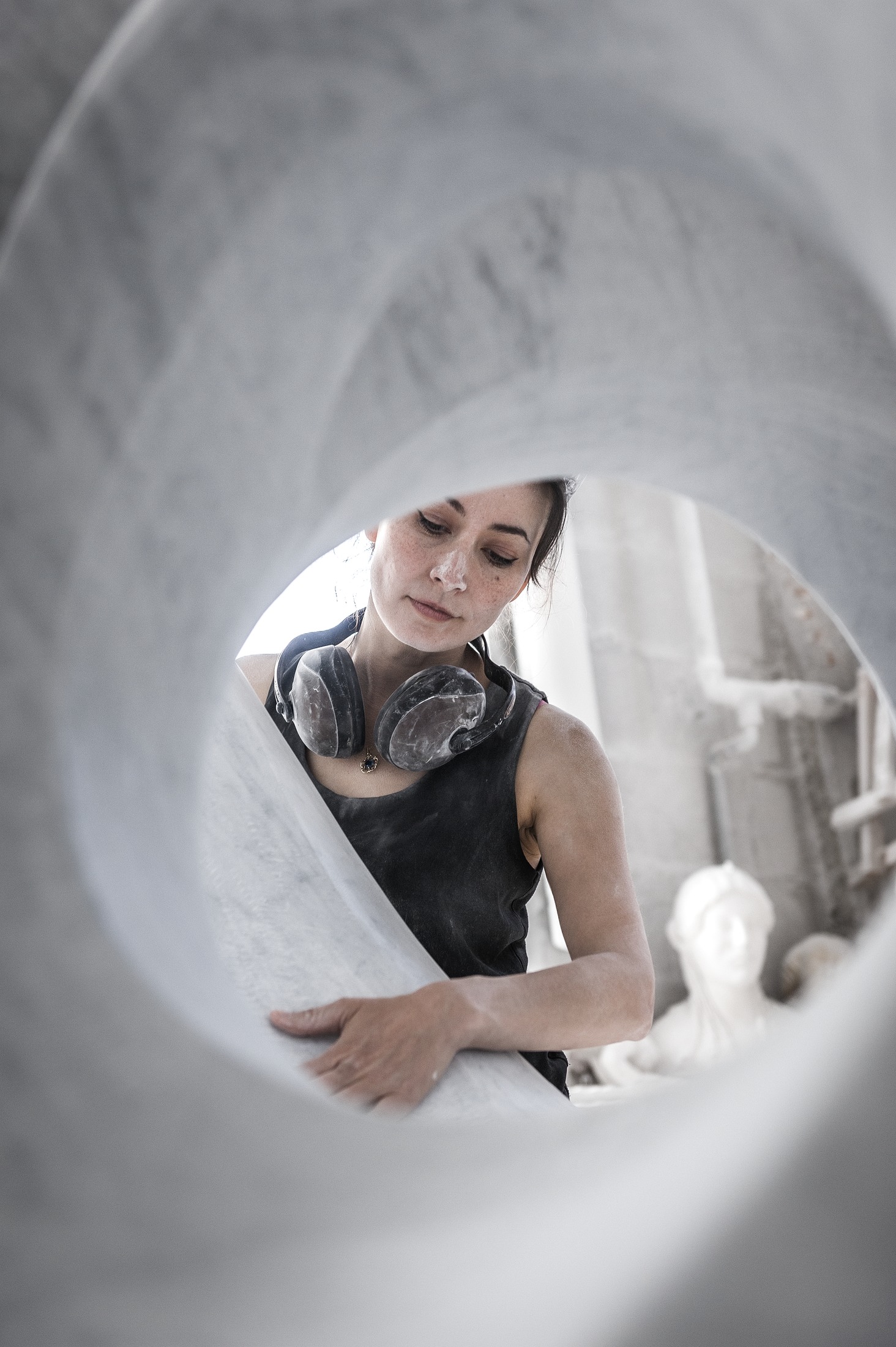 Yoko Kubrick seen through a marble sculpture in Pietrasanta